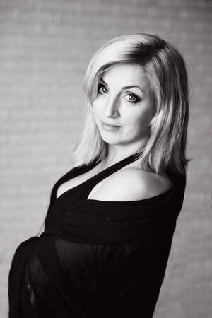 pretty sensual middle age blonde woman in the morningの写真素材