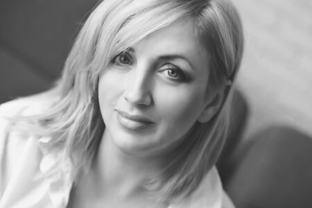 portrait of pensive woman with blonde hairの写真素材
