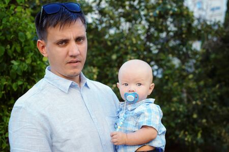father holding his baby boy in   hands outsideの写真素材