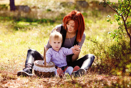 Mom and daughter on the fall meadowの写真素材