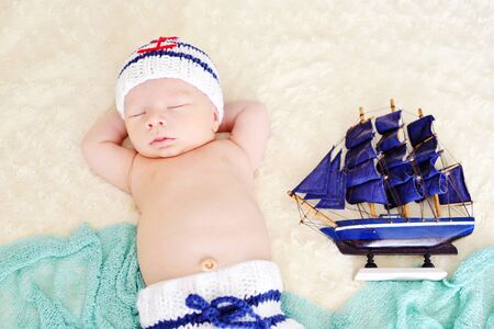 newborn boy is wearing a sailor coscumeの写真素材