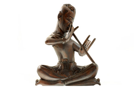 Wooden carved musician playing the fluteの写真素材