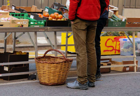 Buying fruit and vegetables at a local marketの写真素材