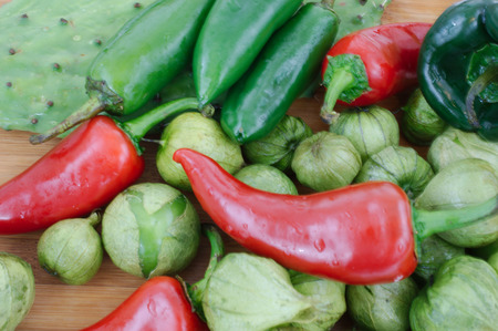 Healthy assortment of hot peppers, tomatillos, and cactusの写真素材