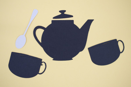Paper cut out of tea pot, cups, and spoonの写真素材
