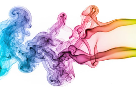 The image showcases a dynamic, swirling pattern of colored smoke or vapor, transitioning through a spectrum of colors from blue to purple, pink, red, orange, and yellow, set against a plain white background.の写真素材