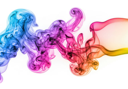 The image captures a mesmerizing dance of colorful smoke, transitioning smoothly from blue to purple, red, and orange, set against a clean white backdrop.の写真素材