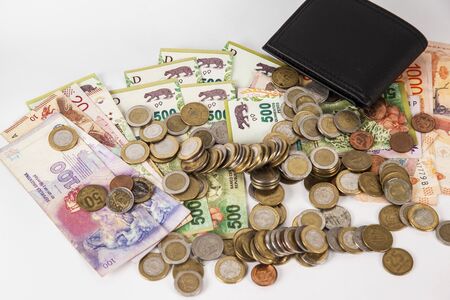 Currency in banknotes of different denominations with coins of different valueの写真素材