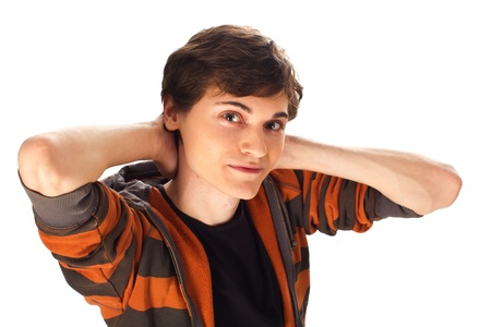 Handsome young man with hands behind the head standing on white backgroundの写真素材