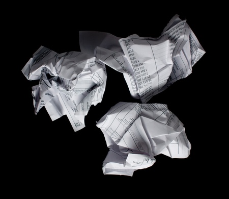 Crumpled financial papers on black background