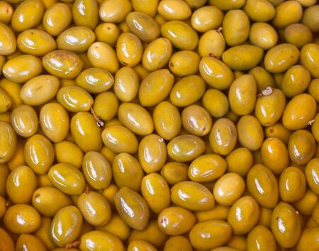 Shiny green olives closeup backgroundの写真素材
