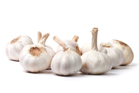 Bunch of garlic bulbs isolated on white background with shadowの写真素材