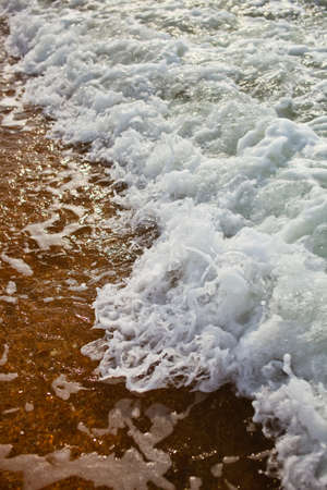 Crashing sea waves on the beach backgroundの写真素材