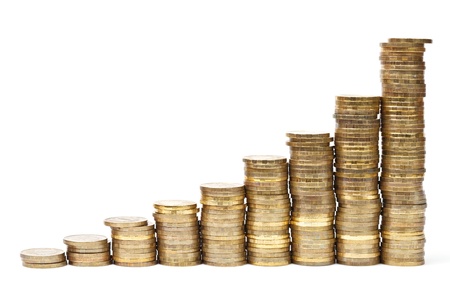 Golden coins stacks forming graph on white background