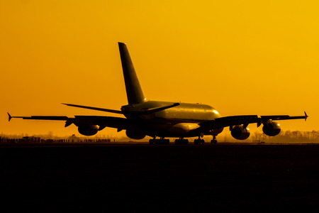 Double decker plane after landing during sunsetの写真素材