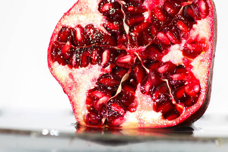 Half of freshness pomegranate over the water with bulbs