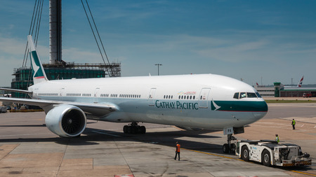 LONDON, UNITED KINGDOM-JUNE 06: Boeing 777-300ER of Cathay Pacific is pushback from terminal for...