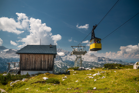 Old yellow cableway on nice day in the Alpsの写真素材