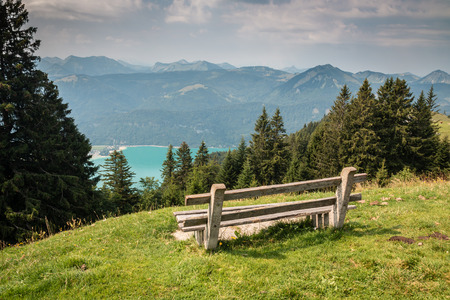 Bench on the hill with perfect view on the Alpsの写真素材