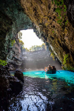 KEFALONIA, GREECE - SEPTEMBER, 13:Melissani Lake Cave: Tourist boat on the lake in Melissani Cave, Kefalonia Island, Greece on September 13, 2019,のeditorial素材