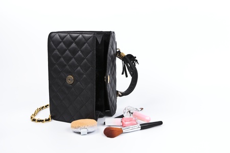 Cosmetics in women bag isolated on white background.の写真素材
