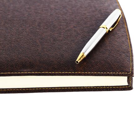 brown red leather notebook with penの写真素材