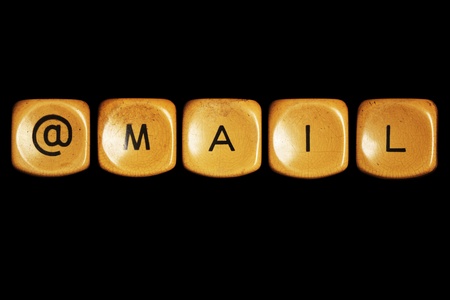 Grunge typewriter keyboard play on  mail words . Isolated on a black background.の写真素材