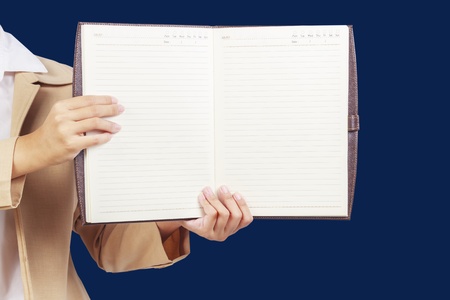 Businesswoman holding  blank notebook in front of herの写真素材