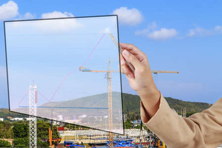 Hand of Secretary show a grow up arrow with construction site background