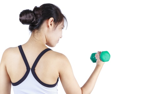 Young asian woman lifting a dumbbellの写真素材