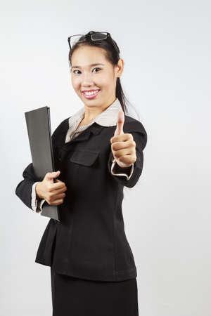 Attractive Asian business woman with thumb upの写真素材