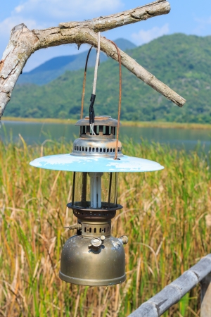 A hurricane-lamp hanging on the dried treeの写真素材
