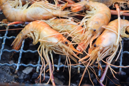 Grilled prawns on flaming grill.の写真素材
