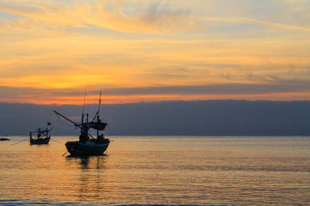 Fishing boats at sunset or sunrise, in Thailand の写真素材