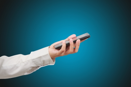 Modern mobile phone in a woman handの写真素材