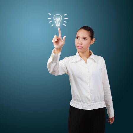Business woman touch screen with lamp symbol. For business concept.の写真素材