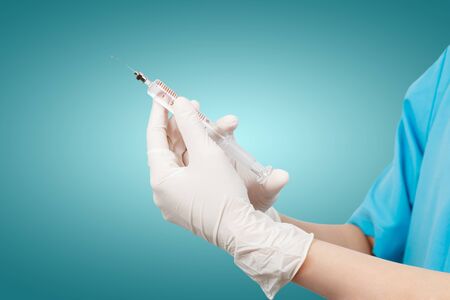 Doctor's hands holding syringe の写真素材