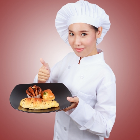 Chef showing bakery dish. の写真素材
