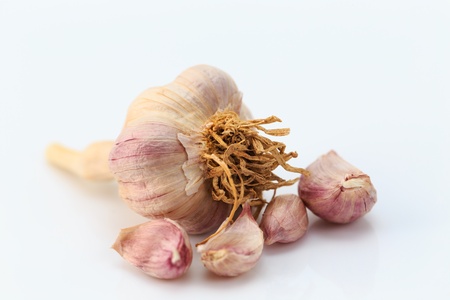 fresh garlic isolated on whiteの写真素材