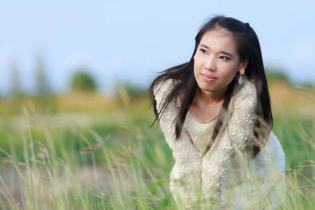 Beautiful Asian woman enjoy nature meadow.の写真素材