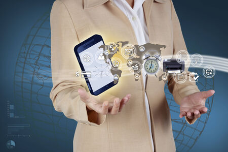 Business woman showing mobile phone and icon web symbol on handの写真素材