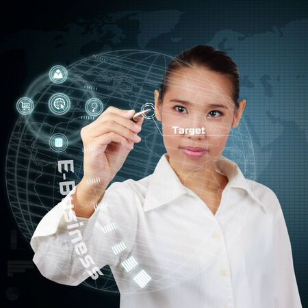 Business woman writing business target on virtual screen.の写真素材