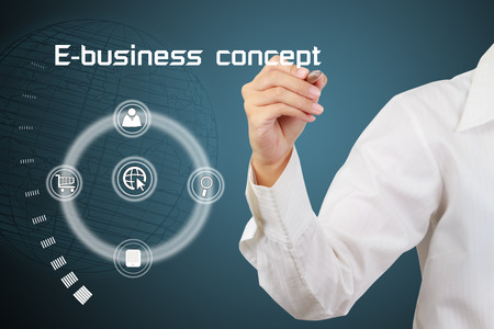 Hand of businessman writing the concept of e-business on virtual screen の写真素材