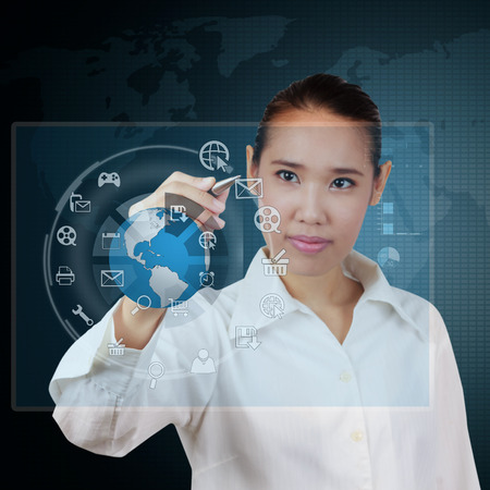 Business woman writing business plan on virtual screenの写真素材