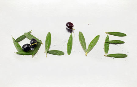 olive letters made with olive oil and olive leaves - clipping pathの写真素材