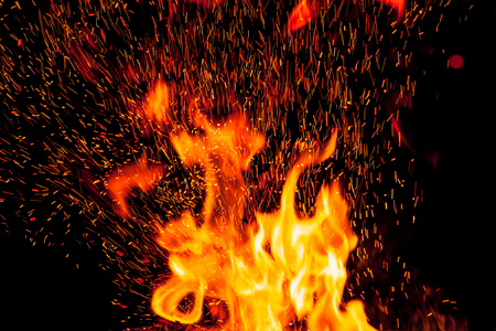 flame and sparks over black background