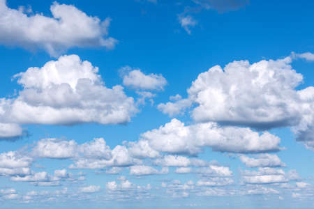 Blue sky background with cumulus clouds