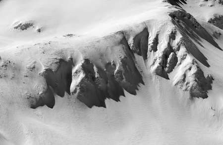 Black and white view of the snow-capped peaks of the Caucasus mountains.