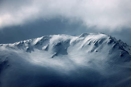 Snowy mountain peaks in the clouds. Beautiful winter landscape. 3D rendering