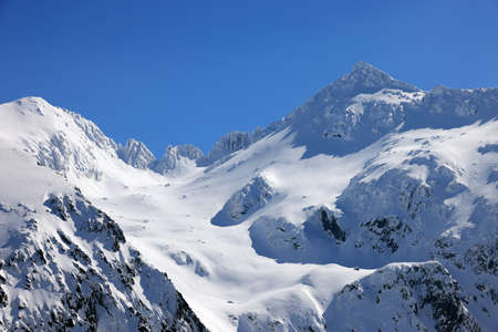 Mountains in the Alps with snow and clear blue sky in winter